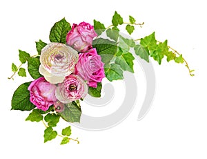 Pink roses and ranunculus flowers with ivy green leaves in a corner arrangement