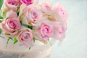 Pink roses in a shabby chic metal bucket