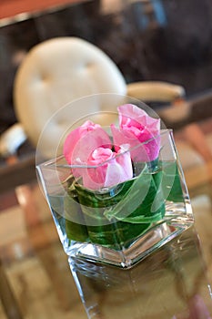 Pink roses table centrepiece in hotel lobby