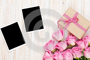 Pink roses and valentines day gift box and two blank photo frame