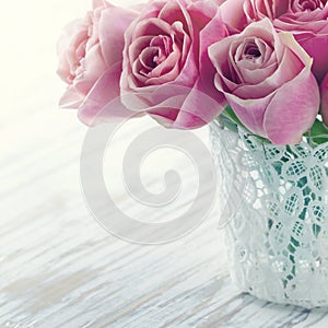 Pink roses in a white lace vase
