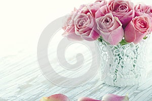 Pink roses in a white lace vase