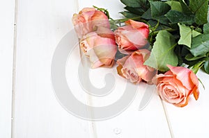 Pink roses on white wooden table