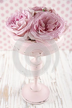 Pink roses in a wooden pastel color vase