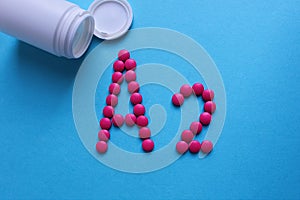 Pink round pills lined with the letter A2