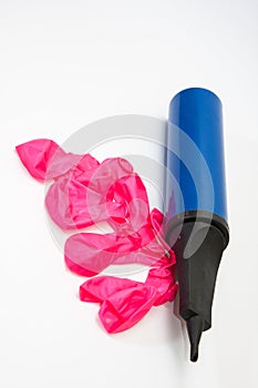 Pink rubber balloons and inflatable pump