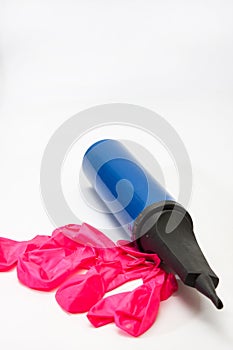 Pink rubber balloons and inflatable pump