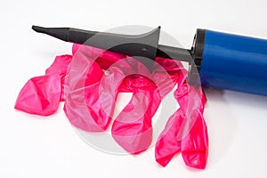 Pink rubber balloons and inflatable pump