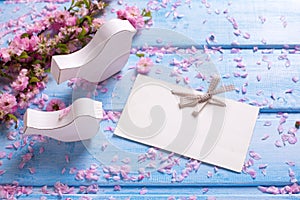 Pink sakura flowers, empty tag and two white wooden decorative