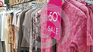 Pink Sale Sign in the Home Clothing Shop in Shopping Mall