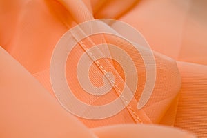 Pink, salmon silk tender colored textile, elegance rippled material