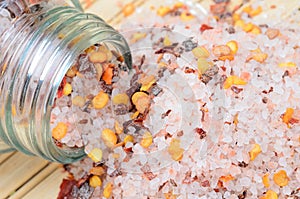 Pink salt with chili seed on table