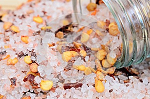 Pink salt with chili seed on table