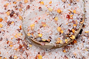 Pink salt with chili seed on table
