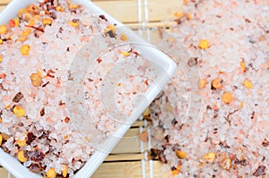 Pink salt with chili seed on table