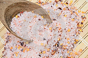 Pink salt with chili seed on table