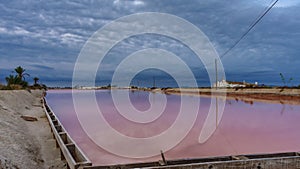 Pink salt pool in saltmine, wide angle timelapse at sunrise
