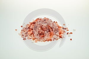 Pink salt on white background. Pink Himalayan salt on white background.