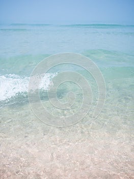 Pink sand beach with small waves and cristal water in Cadiz, Spain