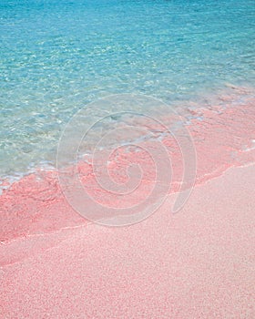 Pink sand beach and turquoise pristine water in Crete Greece
