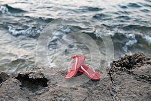 Pink sandals near the water