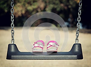 Pink sandals on swing