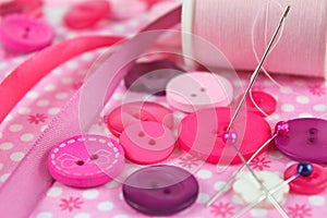 Pink scene of sewing, haberdashery items.