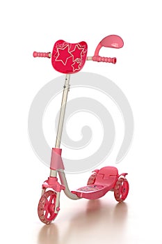a pink scooter for child isolated on white background