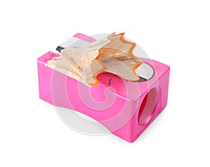 Pink sharpener with pencil shavings on white background