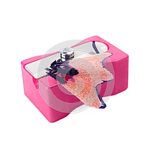 Pink sharpener with pencil shavings on white background