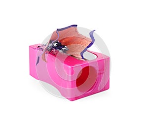 Pink sharpener with pencil shavings on white background