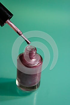 Pink shiny nail polish bottle closeup - Image