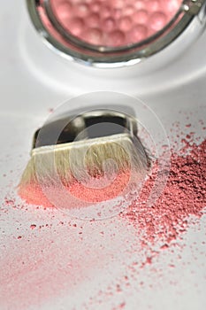 Pink shiny shimmer powder with wide makeup brush