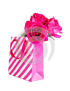 Pink shopping bag and pink roses isolated on white