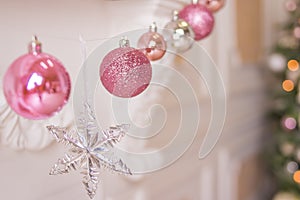 Pink and silver christmas balls and christmas lights on background.New Year greeting cards. Christmas holiday decoration