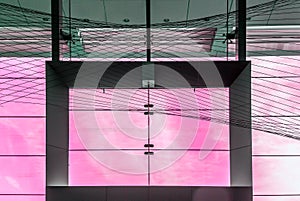 Pink sky behind a modern glass window