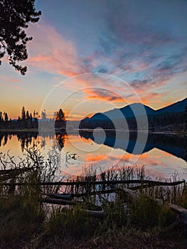 Pink sky over the lake in Rocky Mountain National Park during sunrise in Colorado