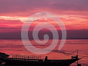 Pink sky in padma river with boat named T-badh