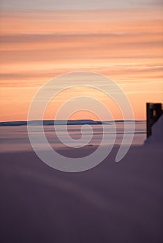 Pink sky, snow all around, skiing resort beauty.