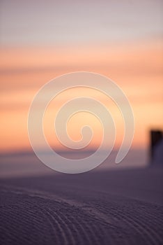 Pink sky, snow all around, skiing resort beauty.