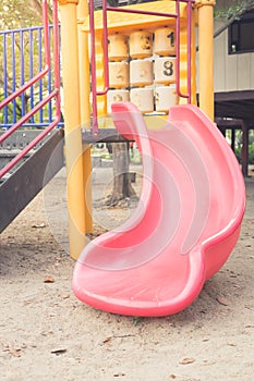 Pink slider tunnel in playground,vintage filtered.