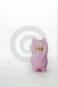 Pink small llama squishy on white empty background. Vertical with copy space. Isolate. Soft toy for kids, antistress