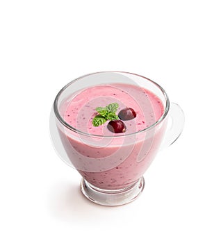 Pink smoothie with cranberry in glass cup on black stone background