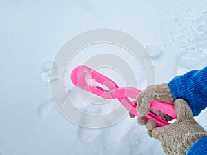 pink snowball maker make balls out of snow.