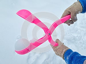 pink snowball maker make balls out of snow.