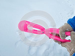 pink snowball maker make balls out of snow.