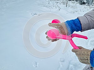 pink snowball maker make balls out of snow.