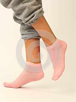 pink sock with copy space on human foot closeup photo on white background