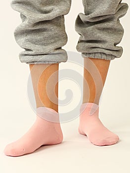 pink sock with copy space on human foot closeup photo on white background