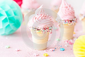 Pink soft serve ice cream with sprinkles